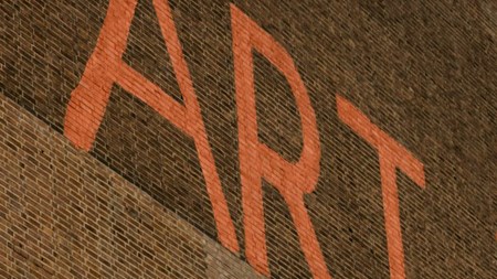 En röd tegelvägg med texten ART i röda versaler. 
