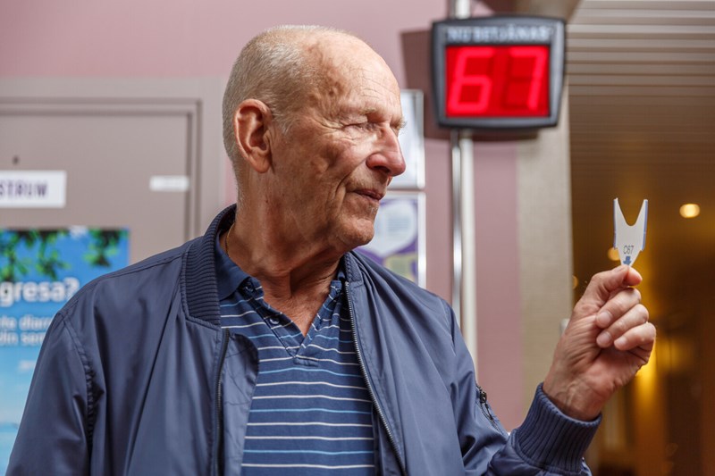 Äldre man med kölapp.